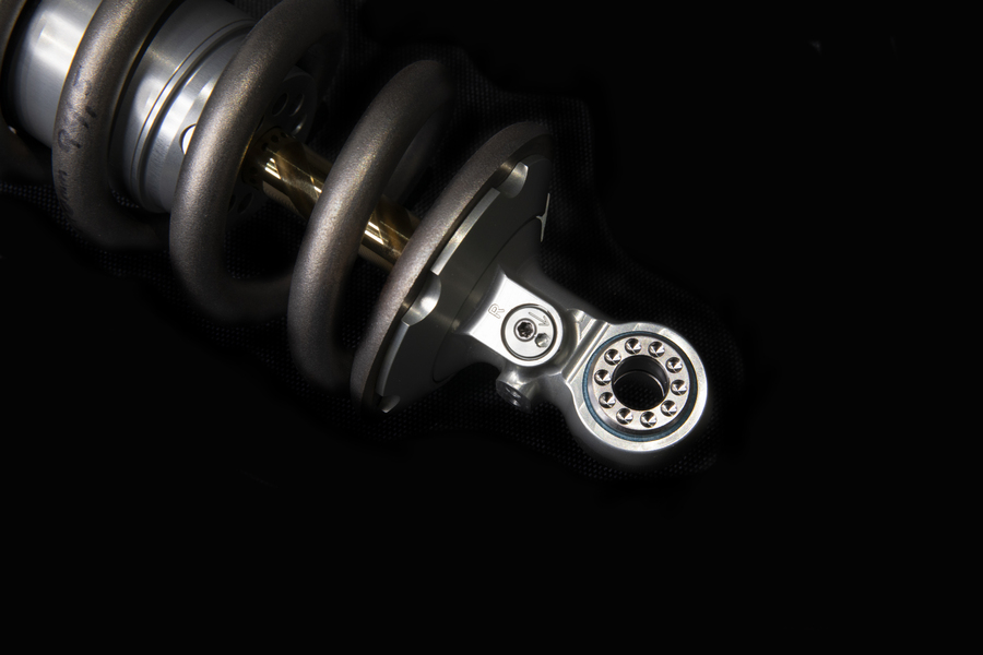 A close-up image of a suspension spring within a motorcycle suspension system, illustrating Lesjöfors’ partnership with Öhlins.