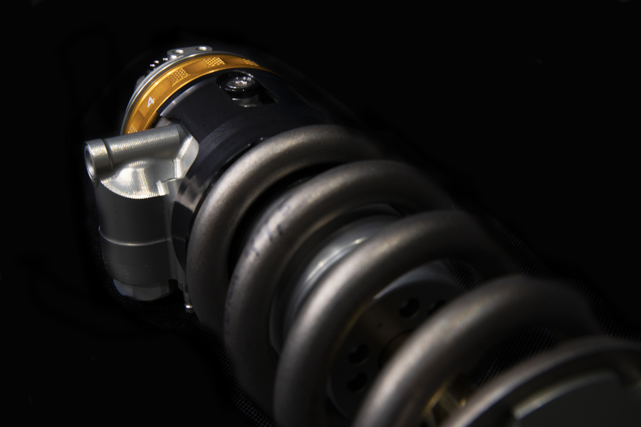 Close-up image of a suspension spring with a shock absorber or dampener.