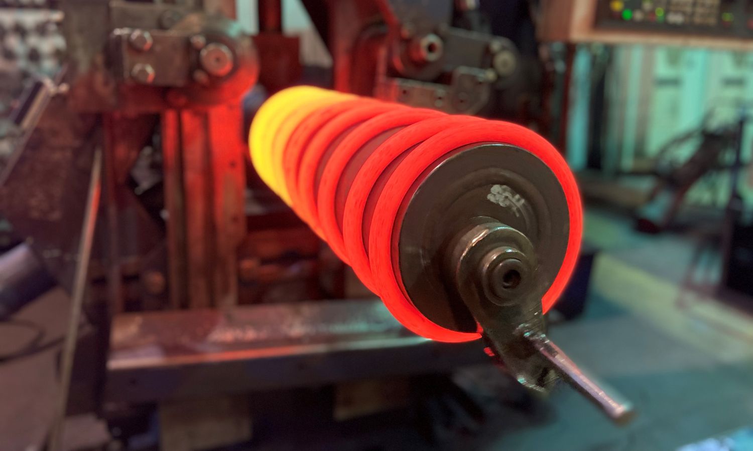 Red-hot steel undergoing the hot coiling process in a rolling mill, with intense heat around a roller, shaping the material for industrial use.